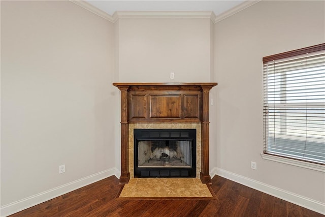 details featuring a tile fireplace, ornamental molding, and hardwood / wood-style floors