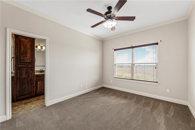 spare room featuring ceiling fan, carpet flooring, and crown molding