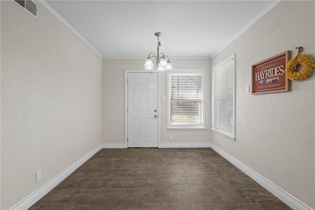 unfurnished dining area featuring baseboards, ornamental molding, and a notable chandelier