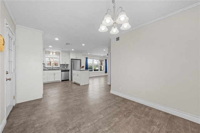 unfurnished living room featuring crown molding, recessed lighting, visible vents, an inviting chandelier, and baseboards