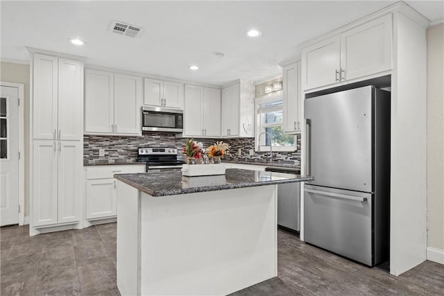 kitchen with visible vents, appliances with stainless steel finishes, and white cabinets