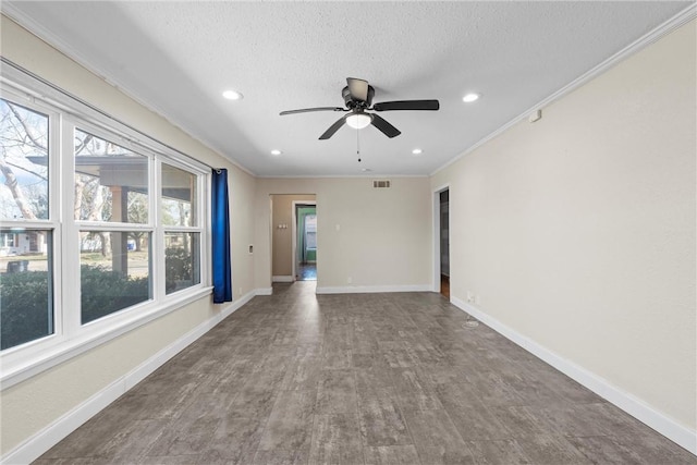 spare room featuring a textured ceiling, baseboards, crown molding, and recessed lighting