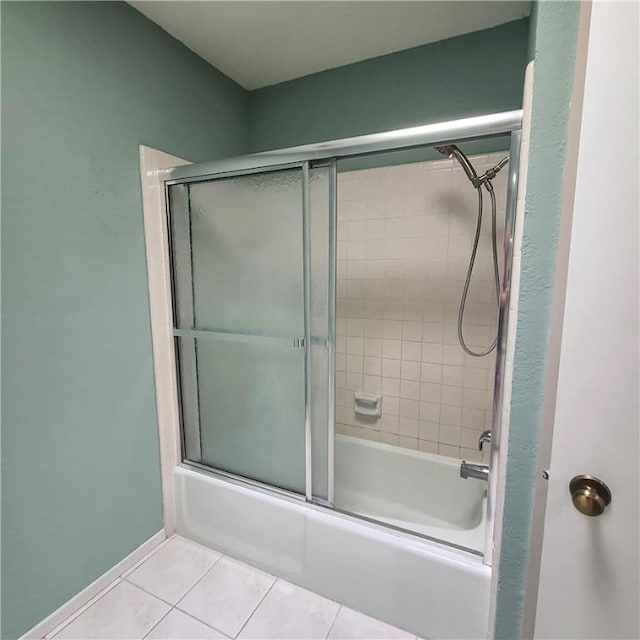 bathroom featuring combined bath / shower with glass door and tile patterned floors