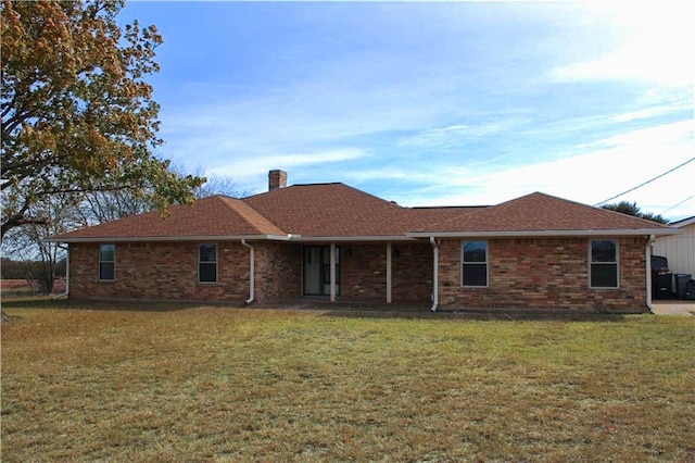 back of property featuring a yard