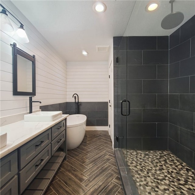 bathroom with vanity and plus walk in shower