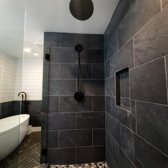 bathroom featuring tile walls and plus walk in shower