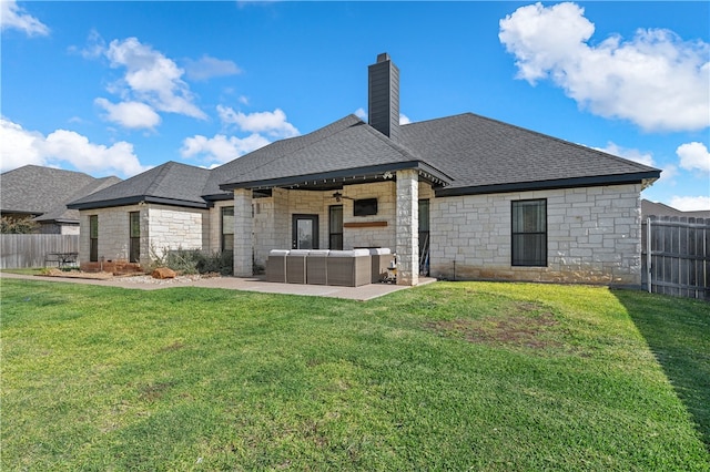 back of house with a lawn, outdoor lounge area, and fence