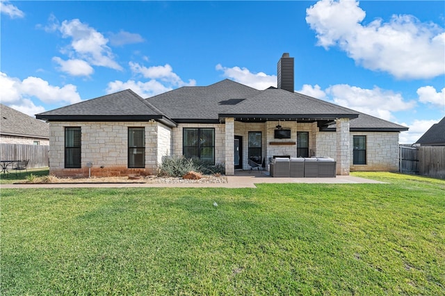 back of property featuring a patio area, a lawn, and a fenced backyard