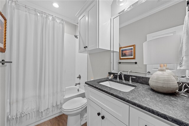 full bath featuring toilet, wood finished floors, shower / bathtub combination with curtain, crown molding, and vanity