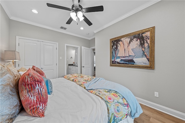 bedroom with wood finished floors, a ceiling fan, visible vents, baseboards, and ornamental molding