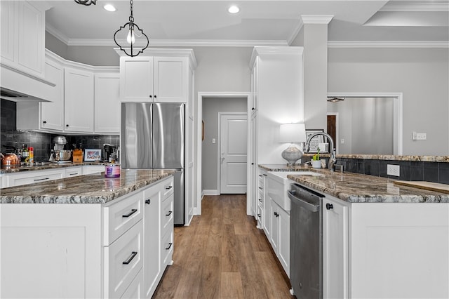 kitchen featuring dark stone countertops, appliances with stainless steel finishes, backsplash, and crown molding