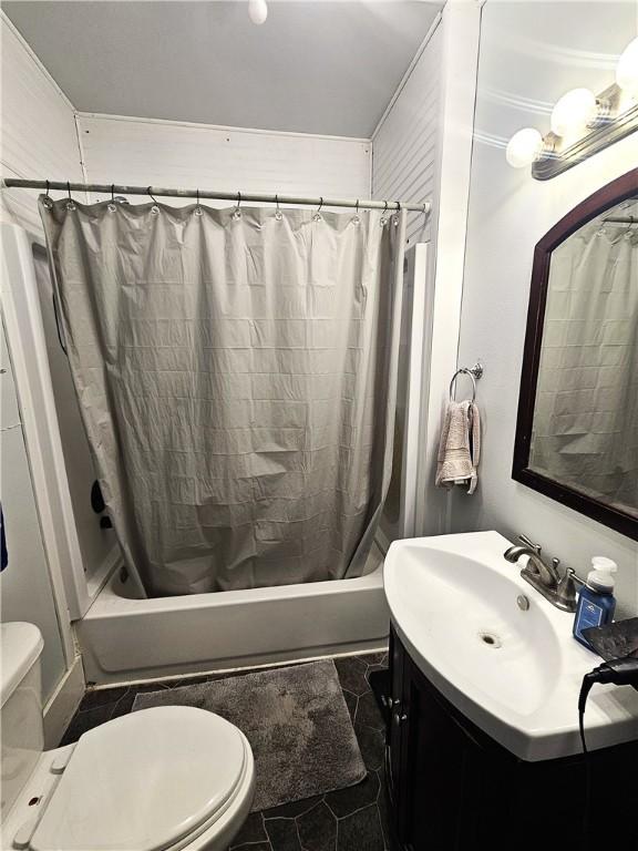 bathroom featuring vanity, toilet, and shower / tub combo with curtain