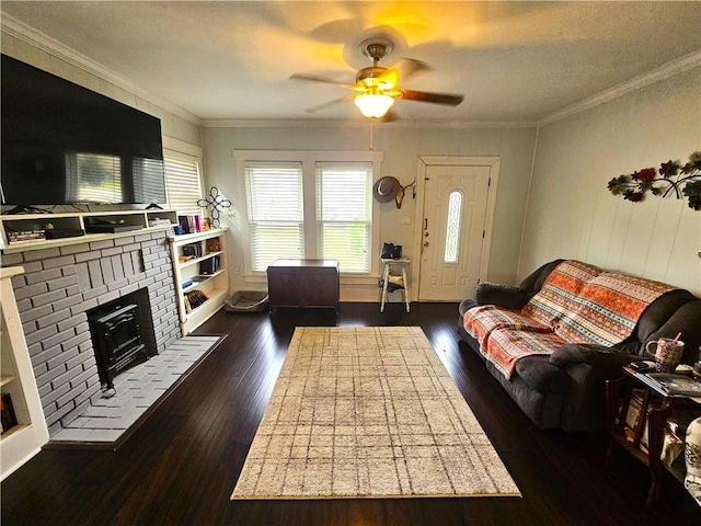 living room with dark wood finished floors, crown molding, a ceiling fan, and a fireplace