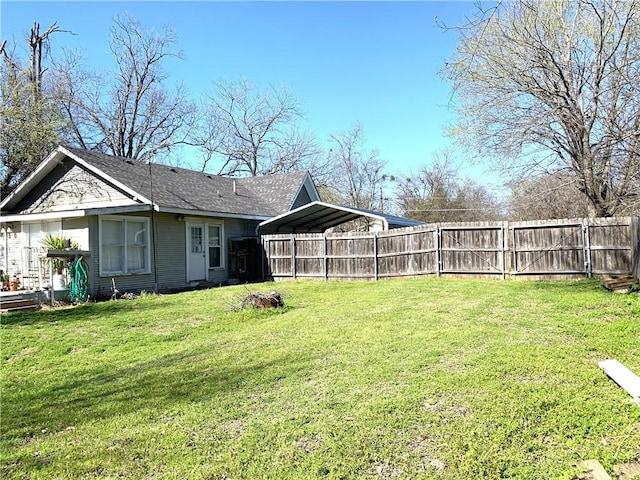 view of yard with a detached carport and fence