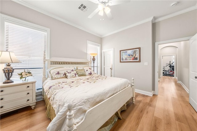 bedroom featuring ceiling fan, light hardwood / wood-style flooring, and ornamental molding