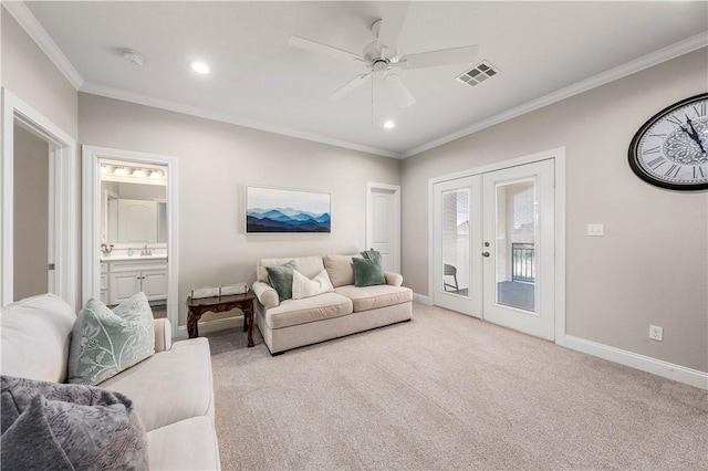 carpeted living room with ceiling fan, sink, ornamental molding, and french doors