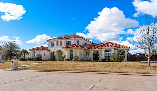 mediterranean / spanish house with a front yard