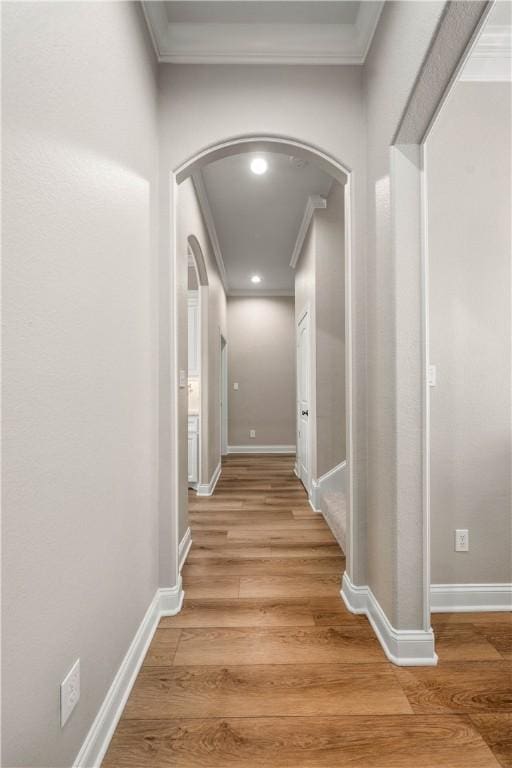 corridor featuring hardwood / wood-style floors and ornamental molding