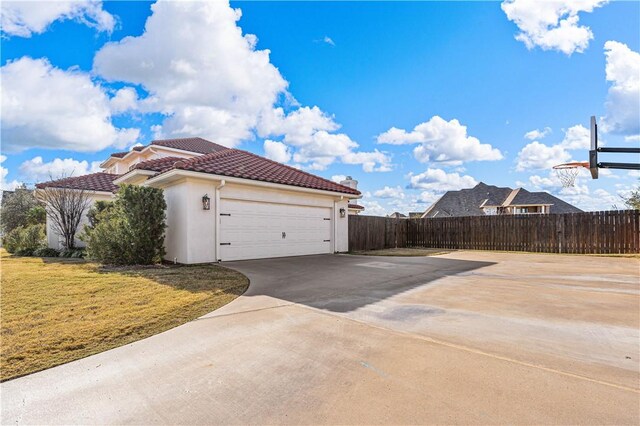 view of home's exterior with a garage and a yard