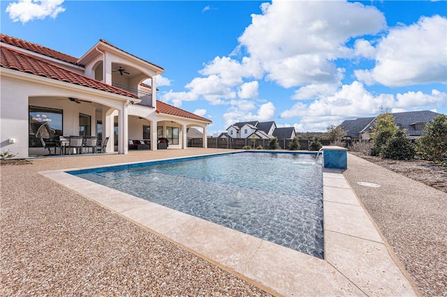 view of swimming pool featuring ceiling fan, pool water feature, and a patio area