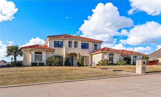 mediterranean / spanish-style house with a front yard