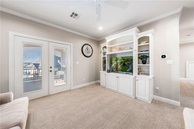 unfurnished living room with ceiling fan, light colored carpet, french doors, and crown molding