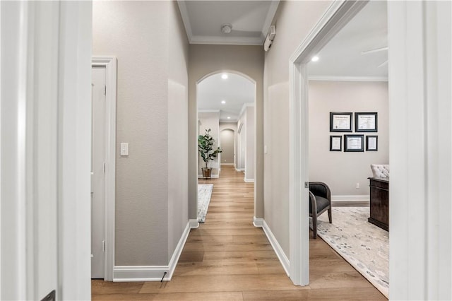 corridor featuring ornamental molding and light hardwood / wood-style floors