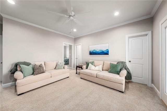 living room featuring ceiling fan, ornamental molding, and light colored carpet