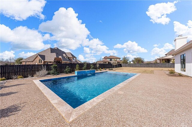 view of pool with pool water feature and a patio