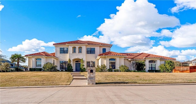 mediterranean / spanish house with a front lawn