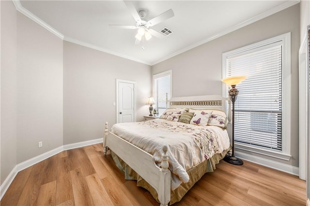 bedroom featuring ceiling fan, ornamental molding, and light hardwood / wood-style flooring