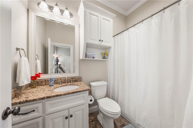 bathroom featuring toilet, vanity, and crown molding