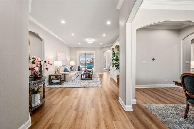 living room featuring light wood-type flooring and ornamental molding