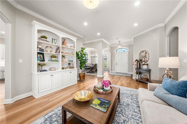 living room with crown molding and light hardwood / wood-style flooring