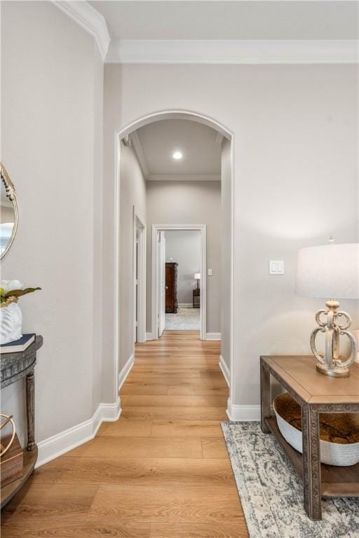 hall with crown molding and light wood-type flooring