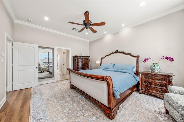 bedroom with ceiling fan, hardwood / wood-style flooring, and ornamental molding