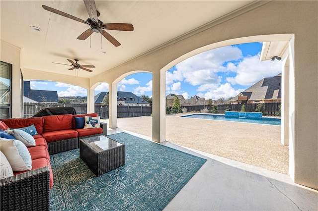 view of patio with ceiling fan, outdoor lounge area, a fenced in pool, and pool water feature