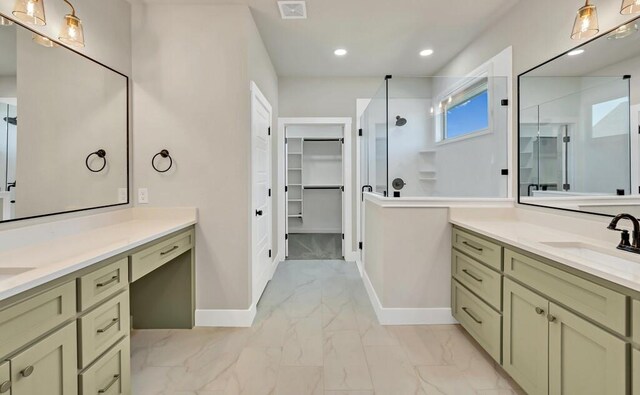 bathroom with vanity and a shower with door