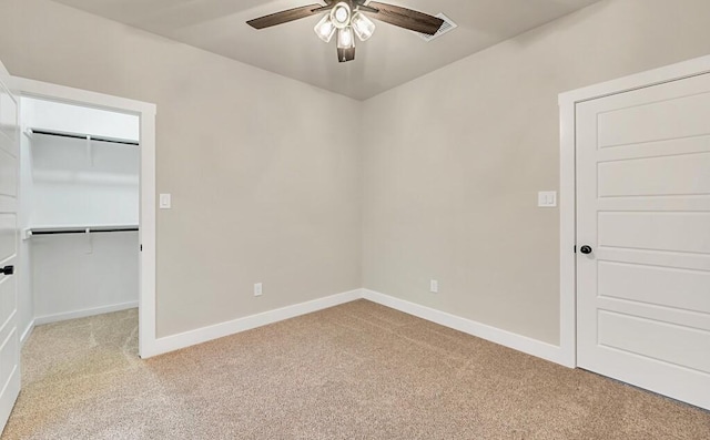 unfurnished bedroom with ceiling fan, light colored carpet, and a closet