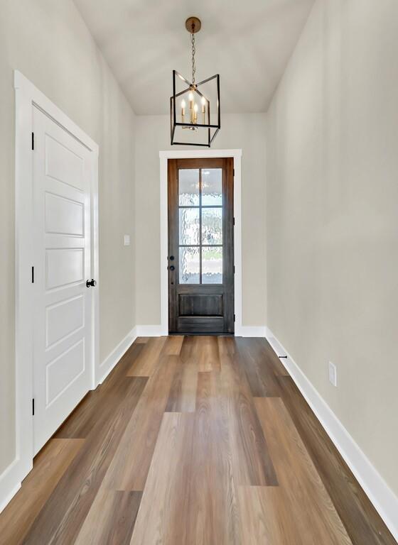 entrance foyer with a chandelier and hardwood / wood-style flooring