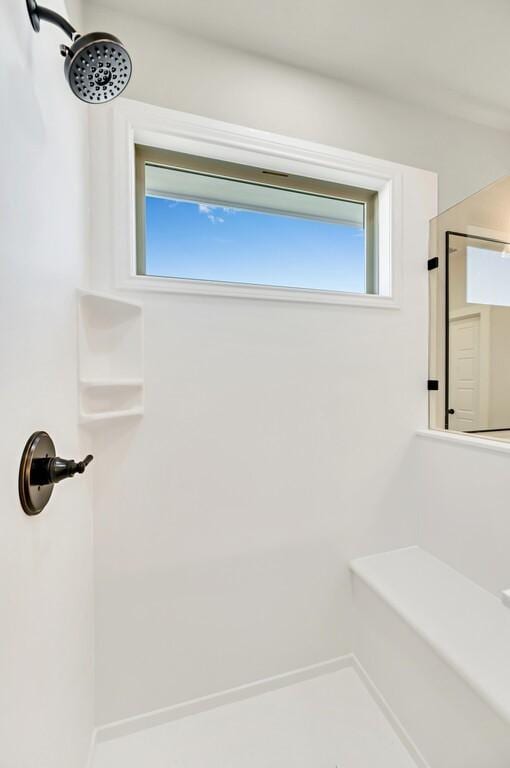 bathroom with plenty of natural light and a shower