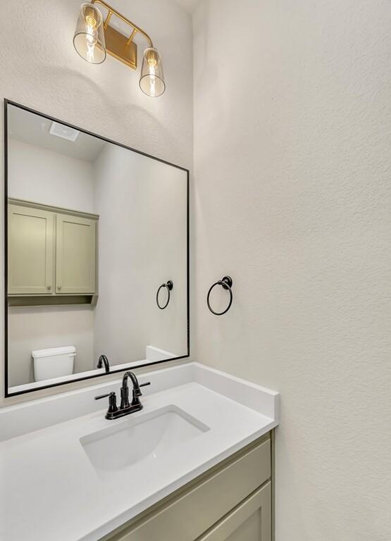 bathroom with vanity and toilet