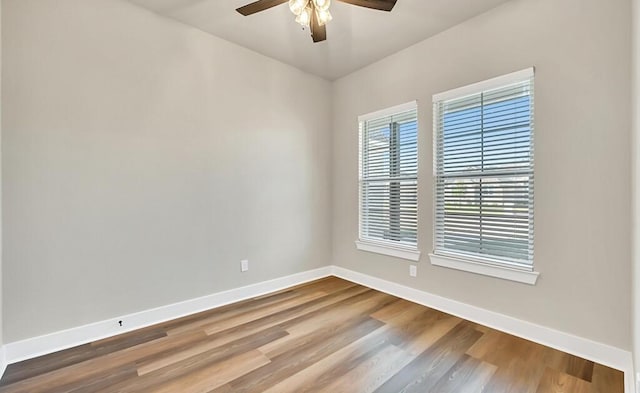 empty room featuring hardwood / wood-style floors and ceiling fan