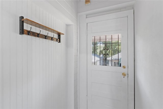 doorway featuring wooden walls