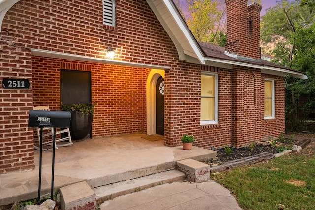 view of exterior entry at dusk