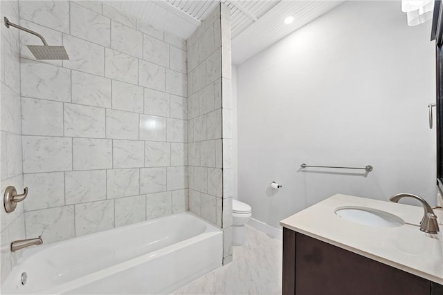 full bathroom with vanity, tiled shower / bath combo, and toilet