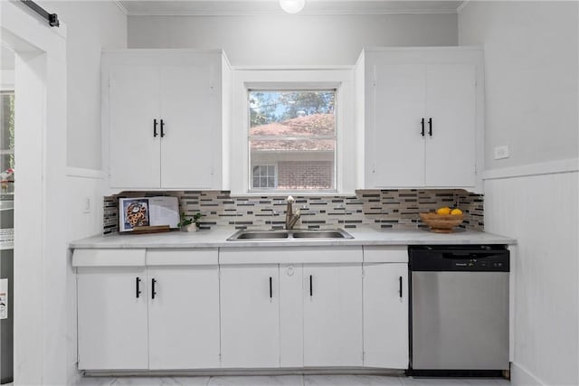 kitchen with backsplash, dishwasher, white cabinets, and sink