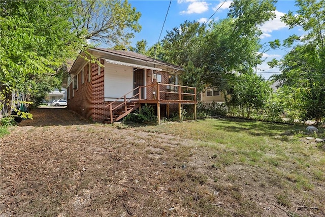 rear view of property featuring a wooden deck