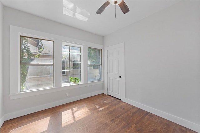 spare room with ceiling fan and wood-type flooring