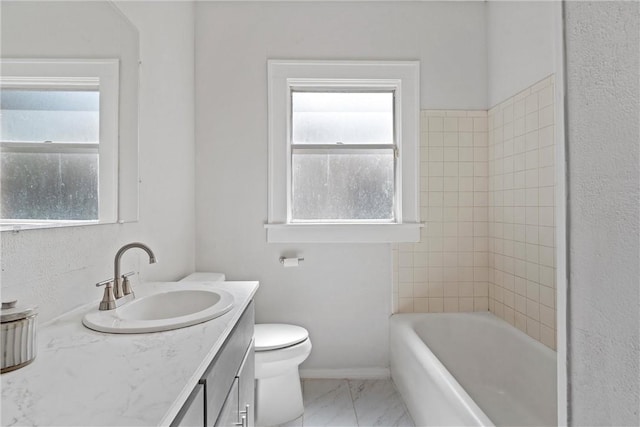 full bathroom featuring vanity, toilet, and tiled shower / bath